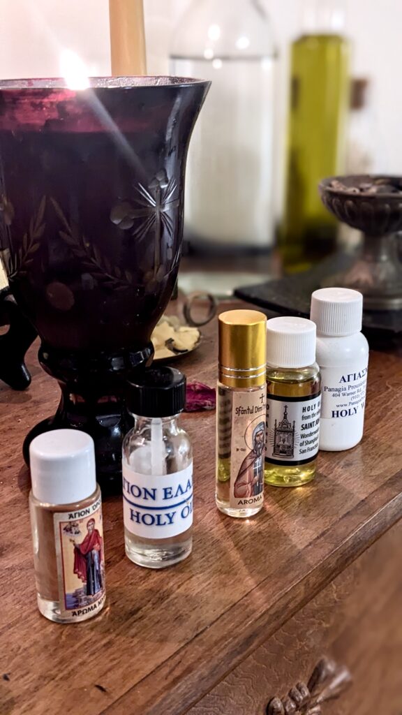 Holy oil and holy water jars in a row on a mantle