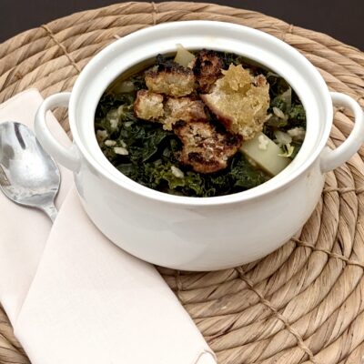 pantry soup with homemade croutons on a table with a napkin and spoon