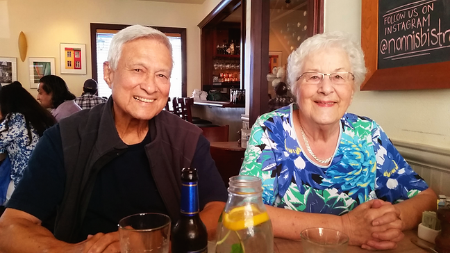 grandparents smiling at a table