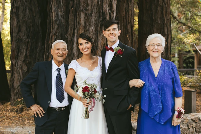 smiling people with the couple at a wedding