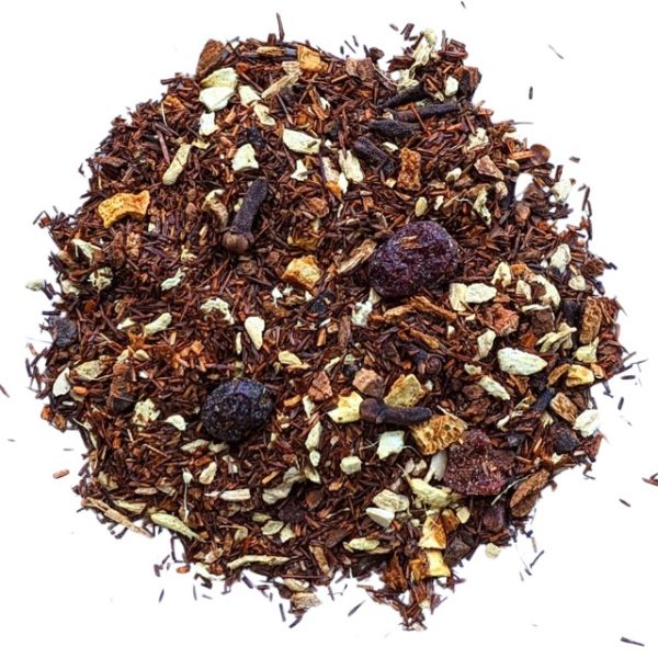 loose leaf tea on a plate with rooibos, clove, ginger, wild cherry bark, orange peel, and cranberries