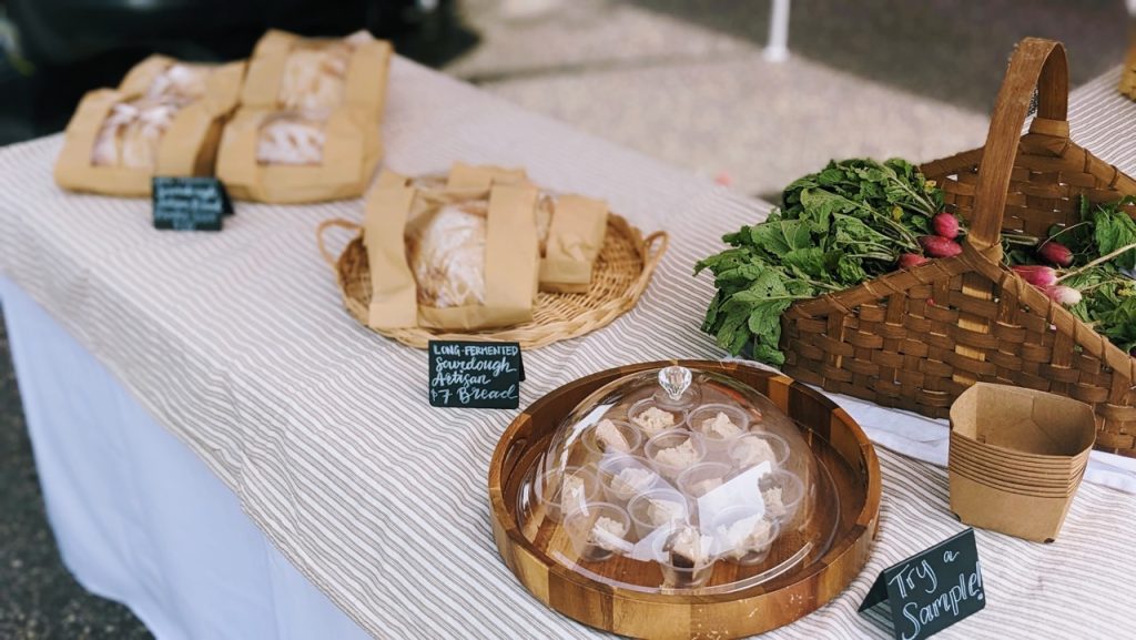 long-fermented sourdough breads in baskets at a farmer's market