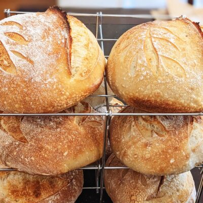 loaves of bread stacked on a drying rack